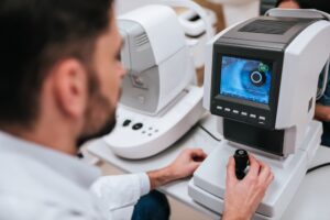 Handsome male doctor ophthalmologist is checking the eye vision